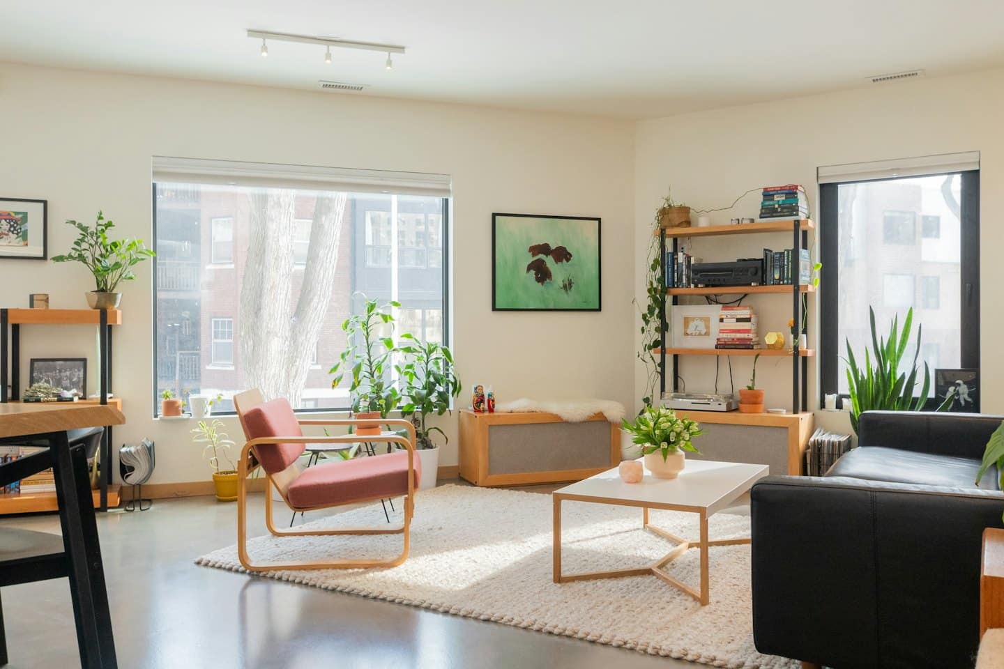 Modern living room with red armchair and plants.