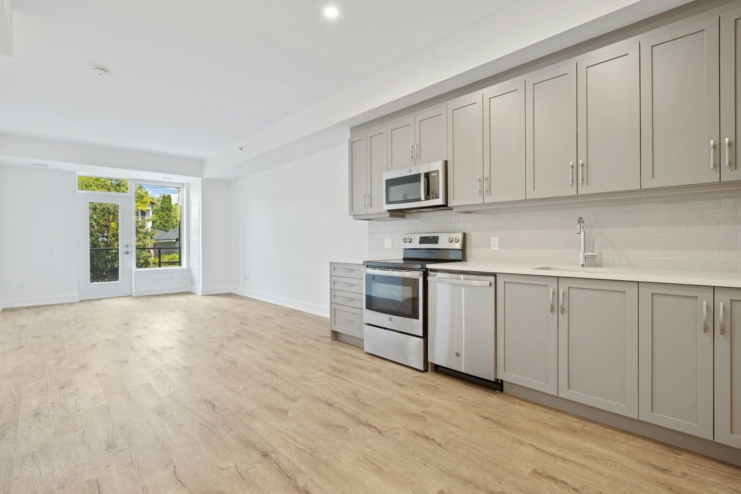 Modern unfurnished apartment with kitchen and balcony.